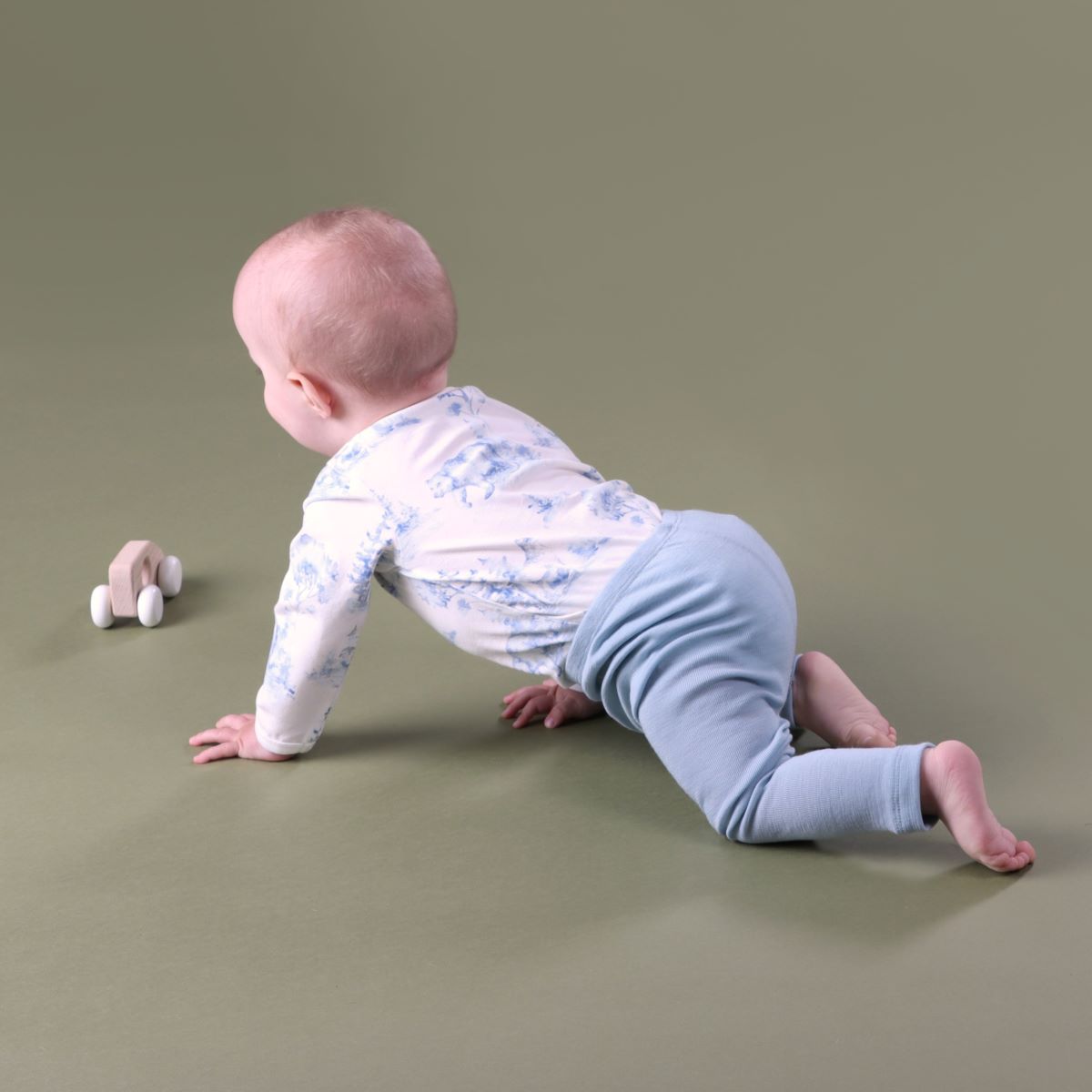 Baby crawling wearing merino leggings pairing it with cotton bodysuit