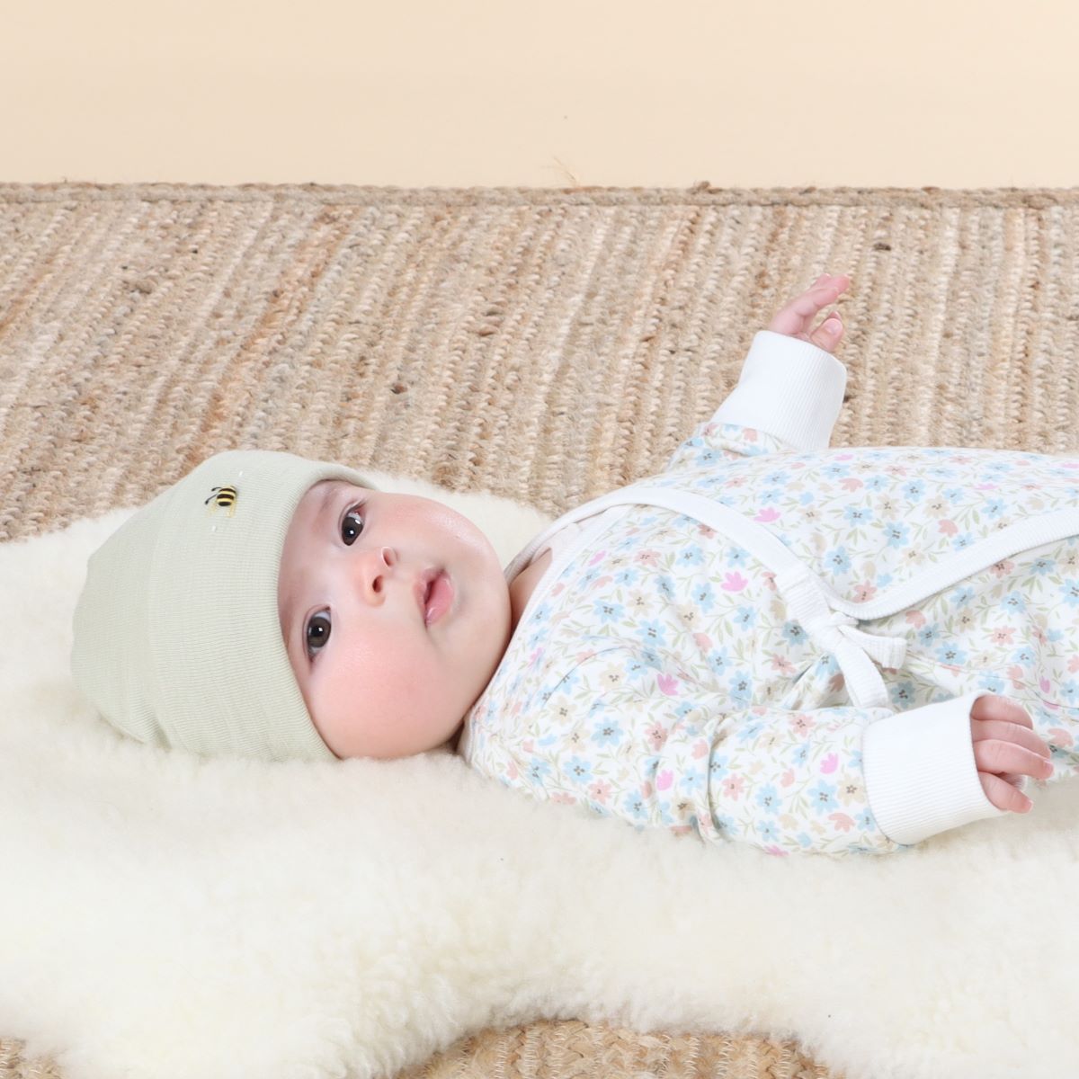Baby wearing Cosy Dreams Merino Beanie in Tea Green from Dimples 