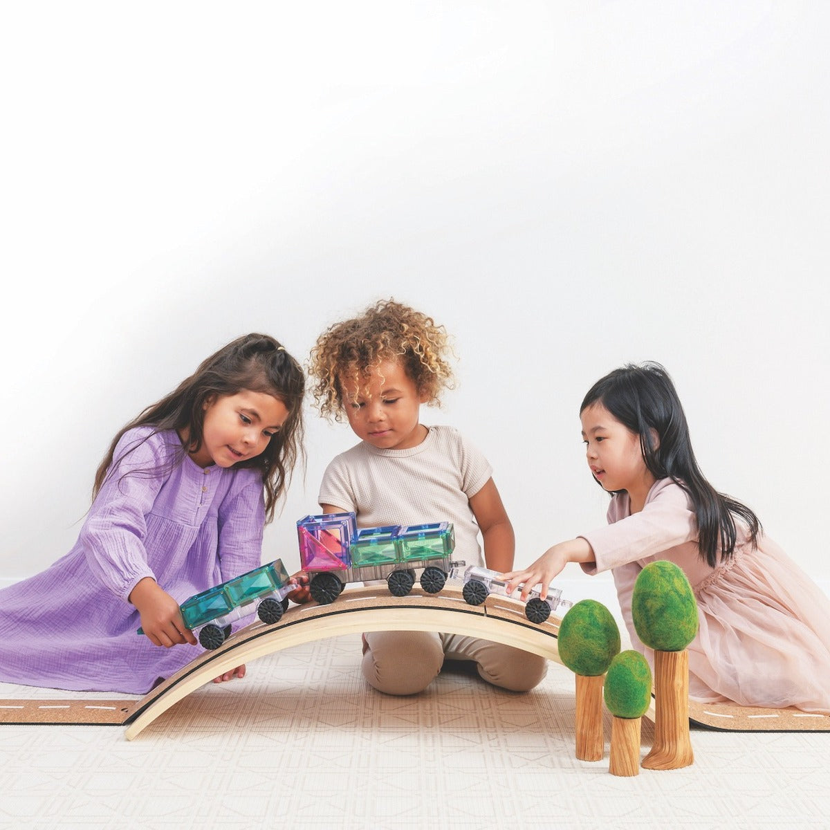 kids playing with toy cars made from pastel magnetic tiles from connetix