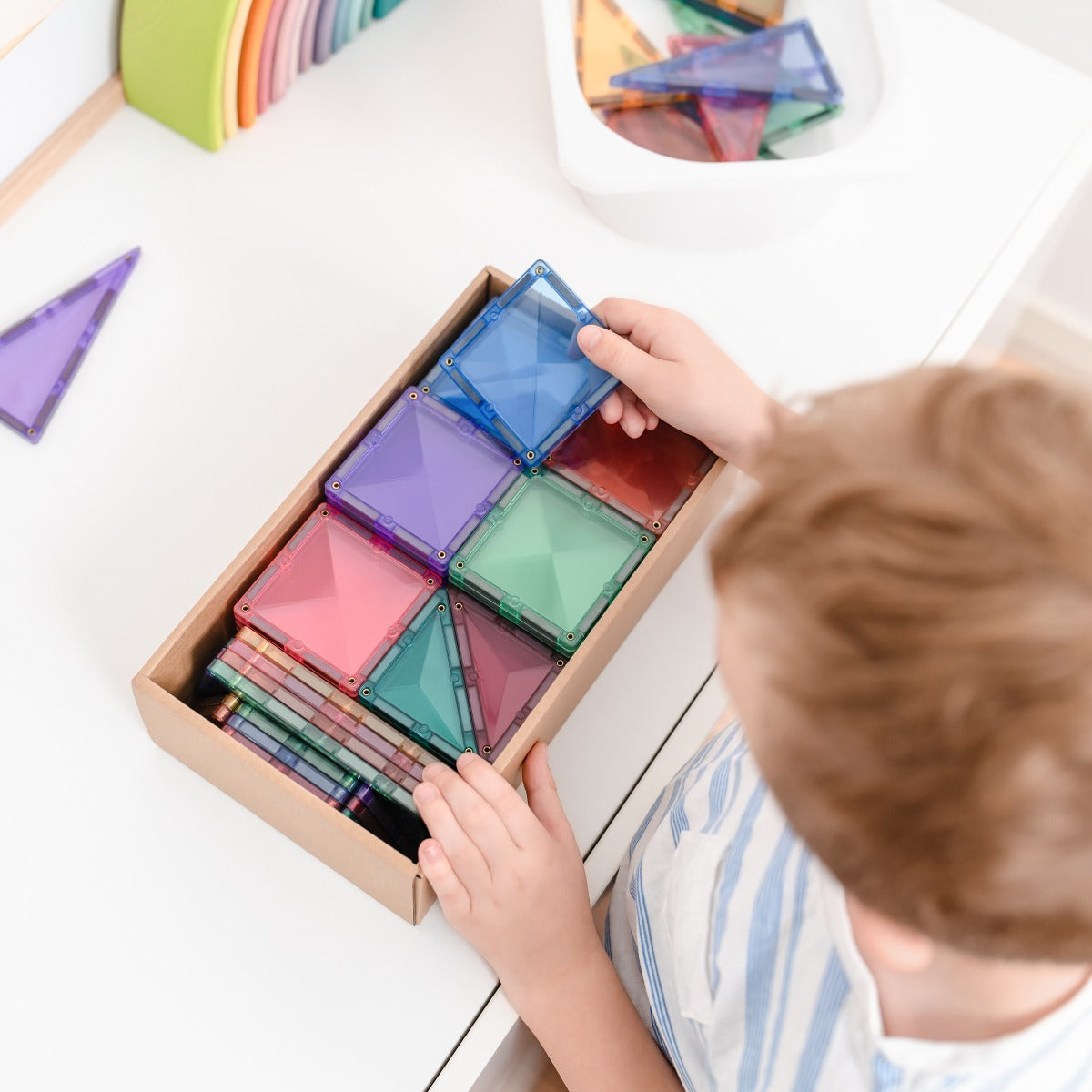 Child pulling out 64pcs Pastel Starter Tiles Pack Box