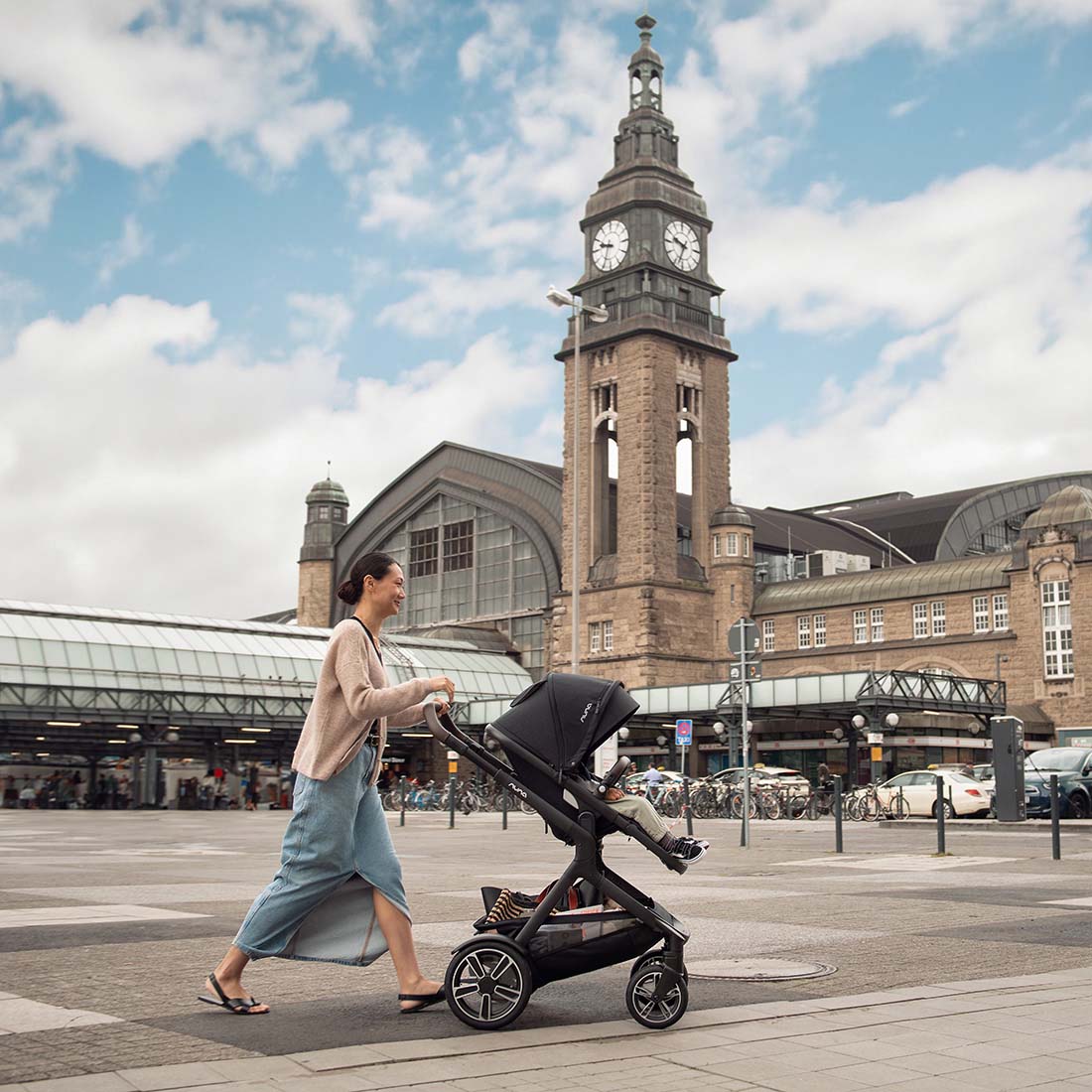 Mother in a city with Demi Next Stroller
