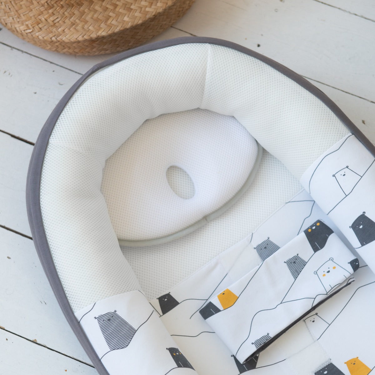 Baby pillow being fitted in a nest