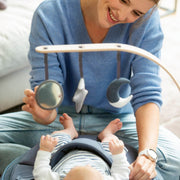 Baby sleeping on Seat'N Swing and staring at Arch with star, sun and moon