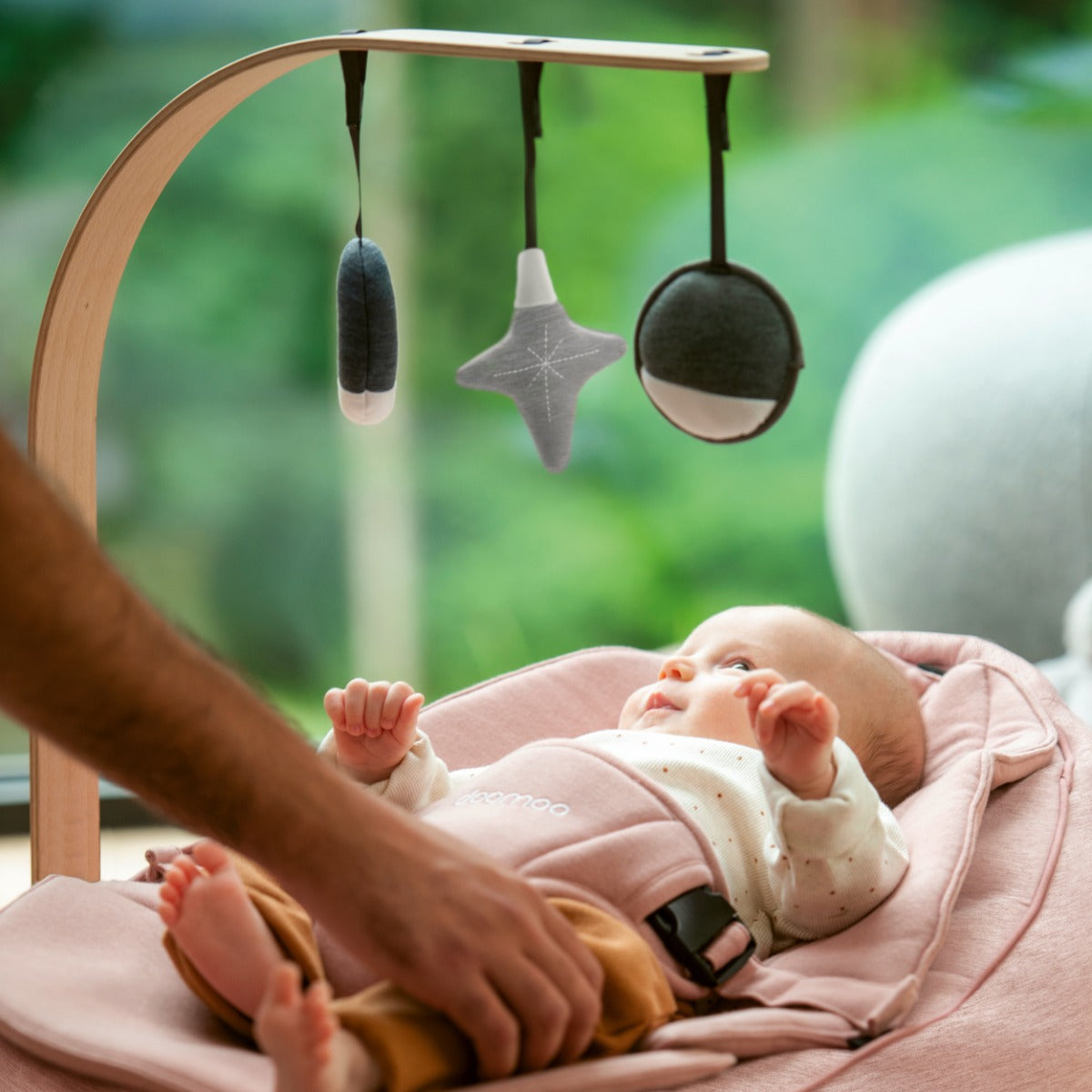 Baby sleeping on Seat'N Swing and staring at Arch with star, sun and moon