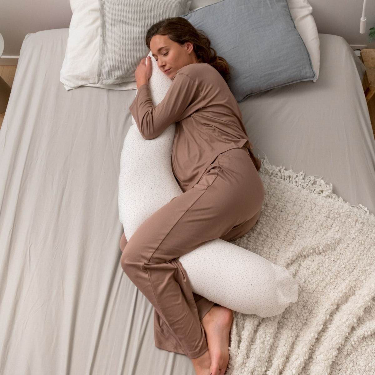 Women sleeping peacefully with Doo Moo Silver Dots Pregnancy Pillow