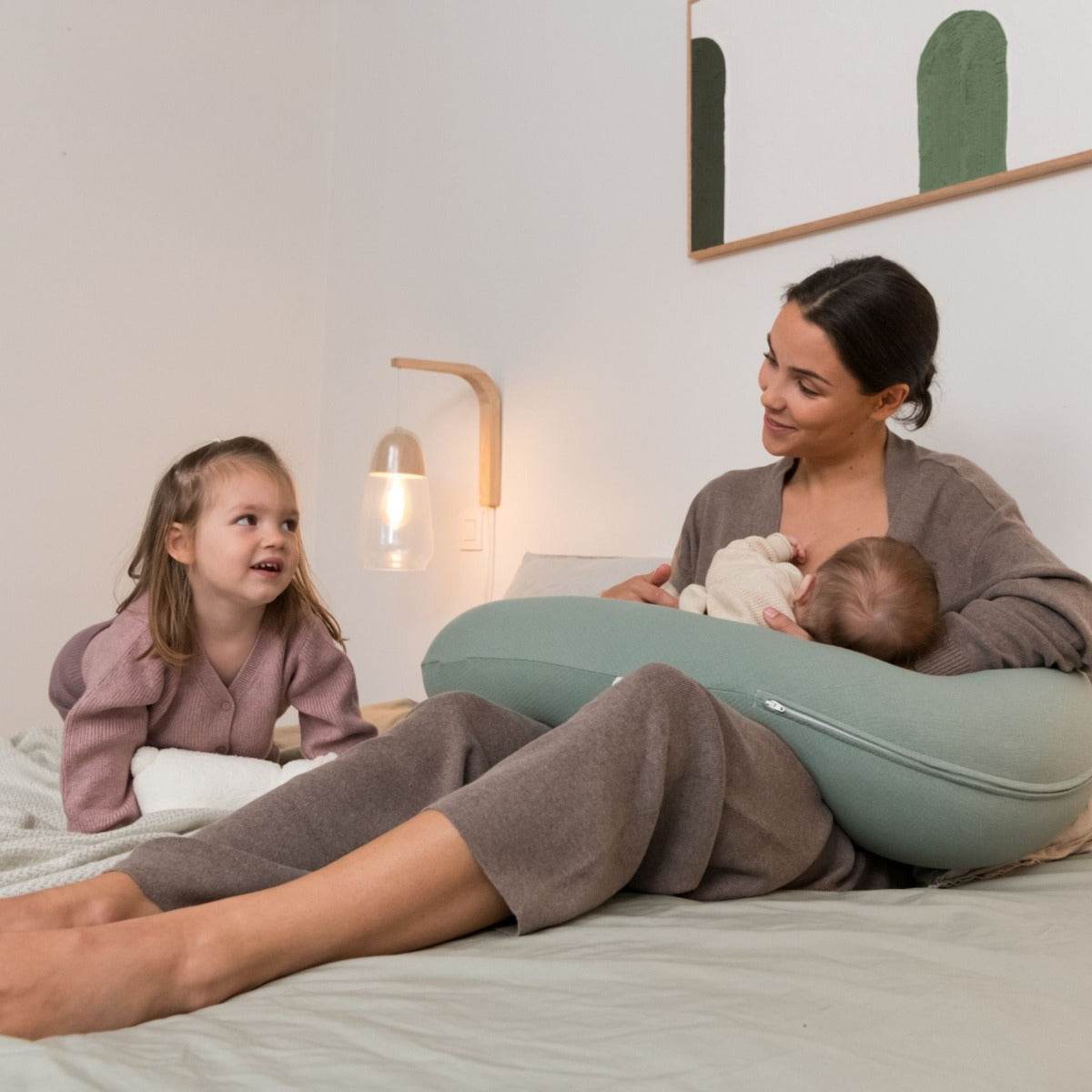 Women breastfeeding baby with Doo Moo Tetra Jersey Green Pregnancy Pillow