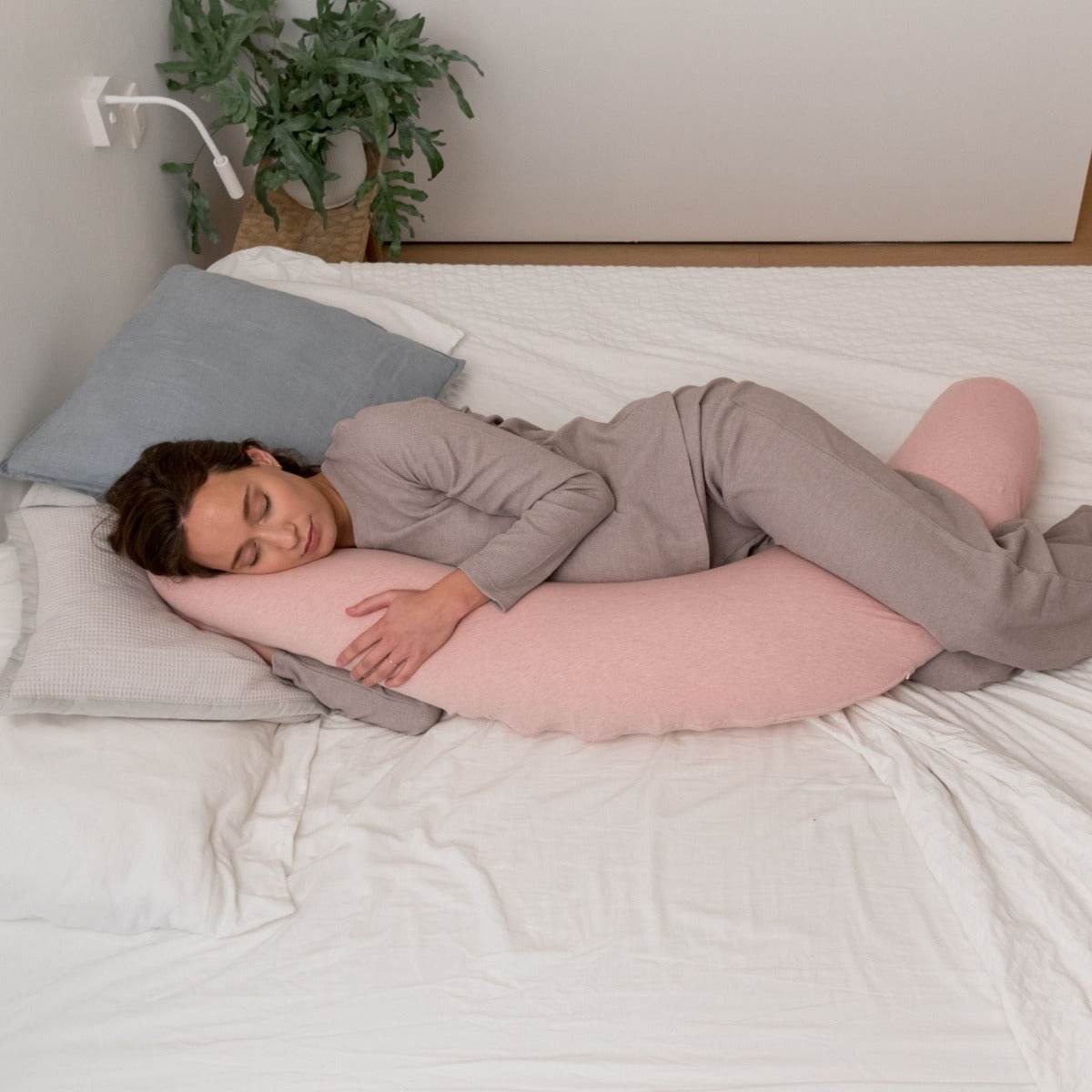 Women sleeping peacefully with Doo Moo Chine Pink Pregnancy Pillow