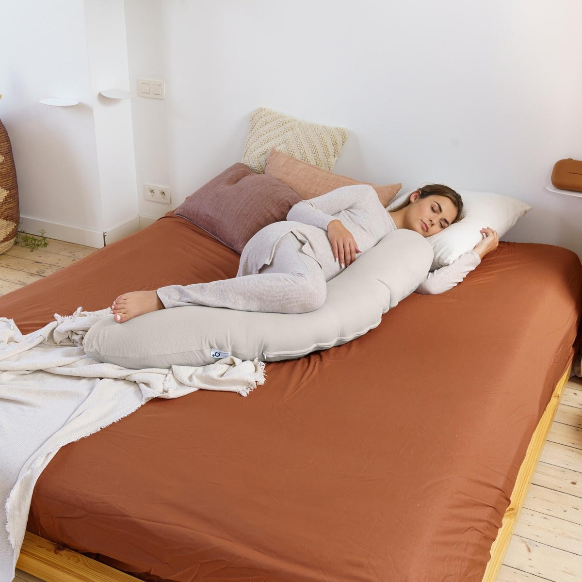 Women sleeping peacefully with Doo Moo Buddy pregnancy pillow cover in Tetra Jersey Sand