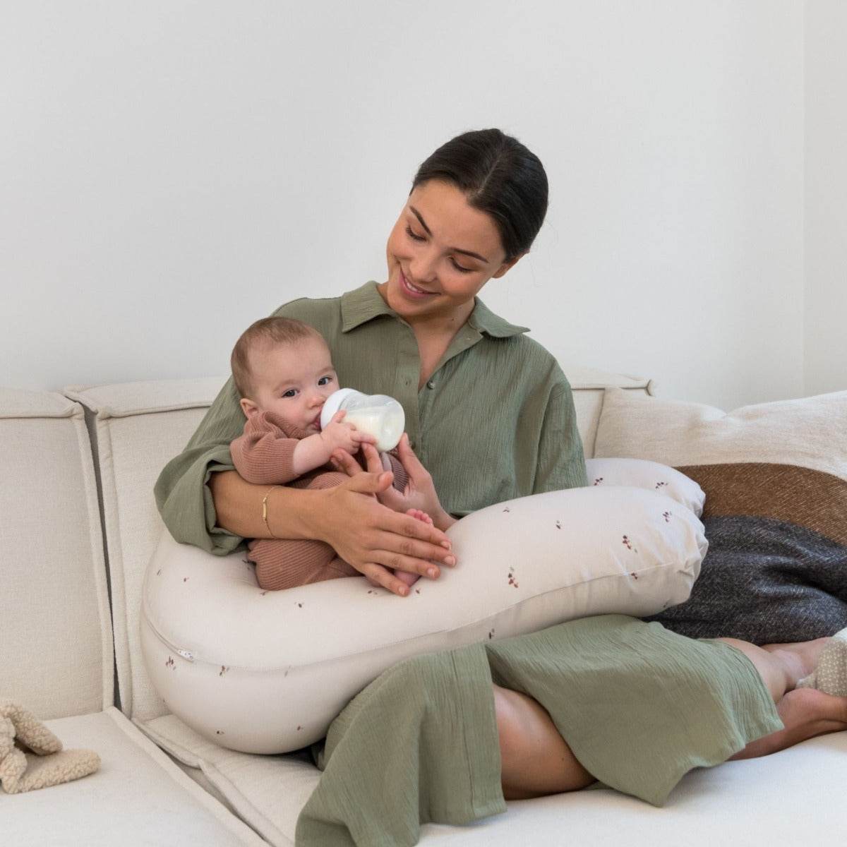 Women bottle feeding baby with Doo Moo Mushrooms Pregnancy Pillow