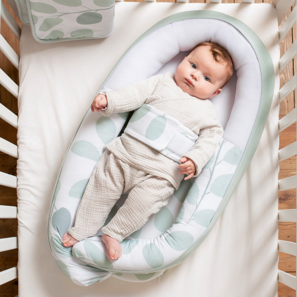 Baby in Doo Moo Cocoon nest in Leaves Aqua Green