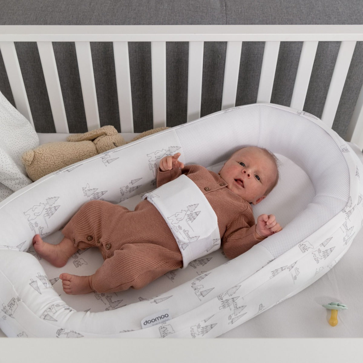 Baby laying in Doo Moo Cocoon nest Bear Family