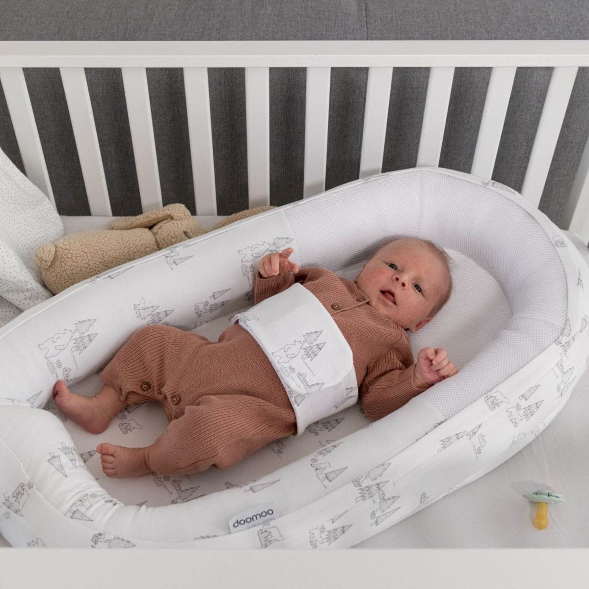 Baby laying in Doo Moo Cocoon nest Bear Family