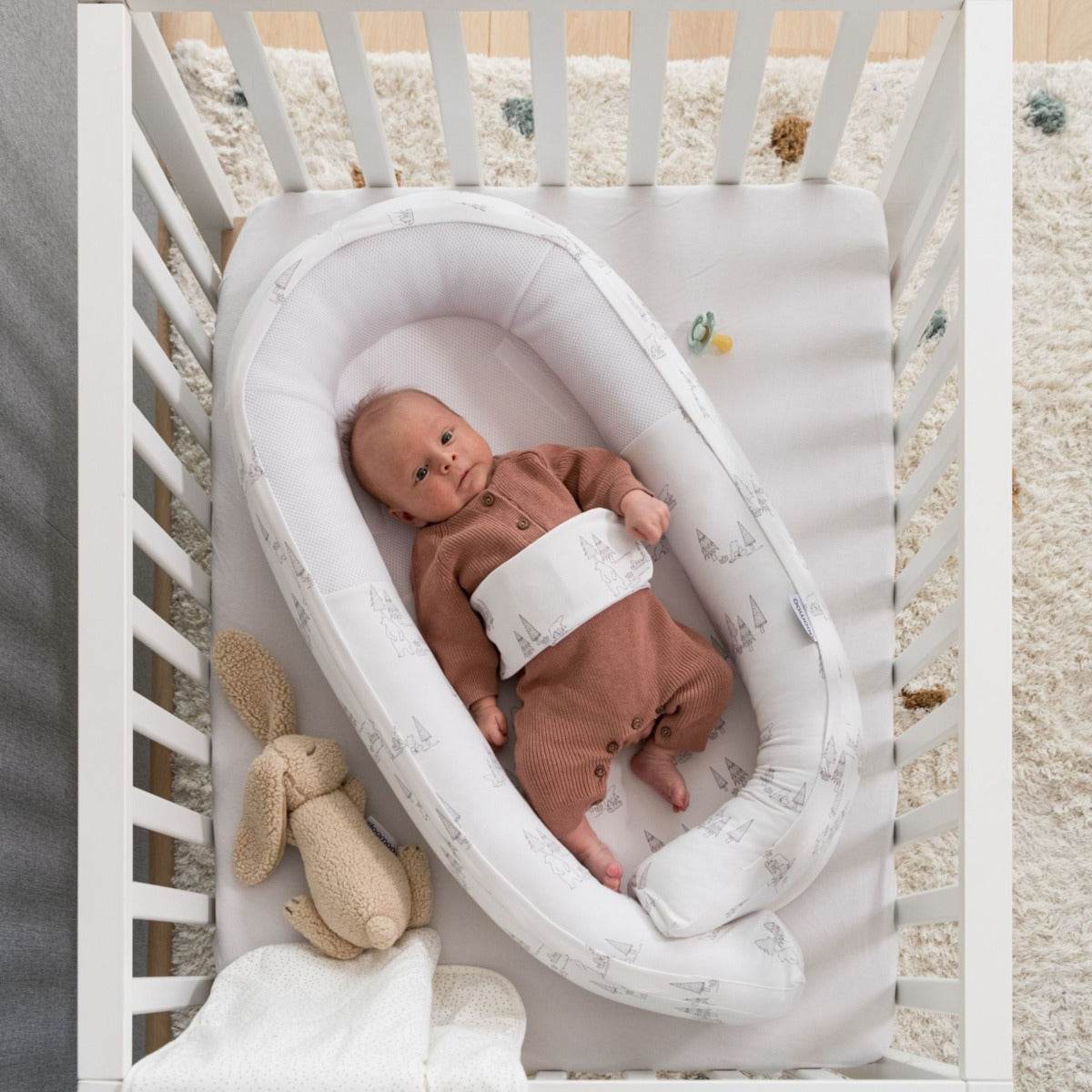 Baby laying in Doo Moo Cocoon nest Bear Family 