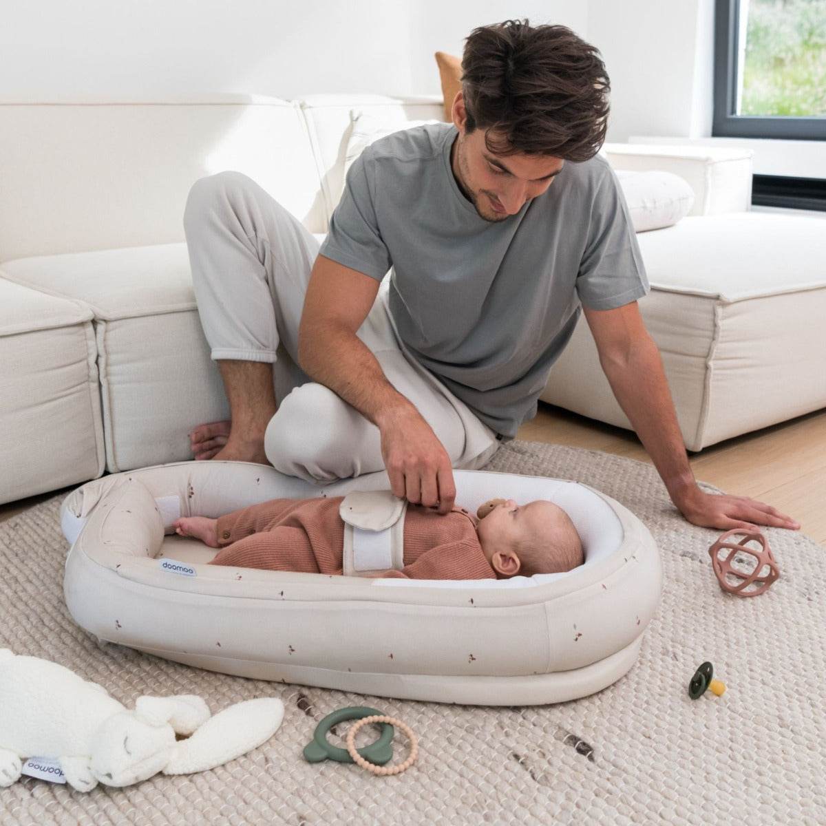 Baby laying in Doo Moo Cocoon nest in mushroom with Father