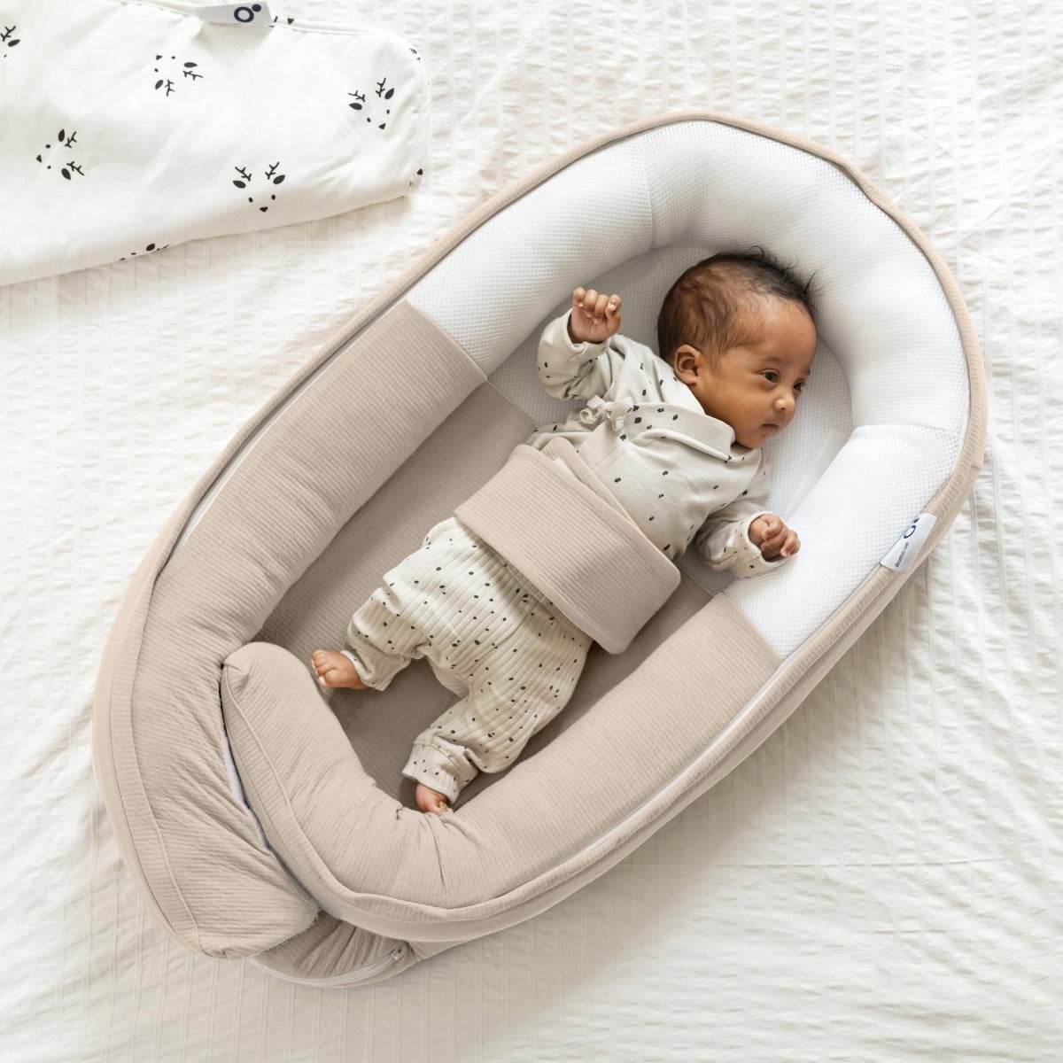 Baby in Baby resting in Doo Moo Cocoon nest in Tetra Jersey Sand 