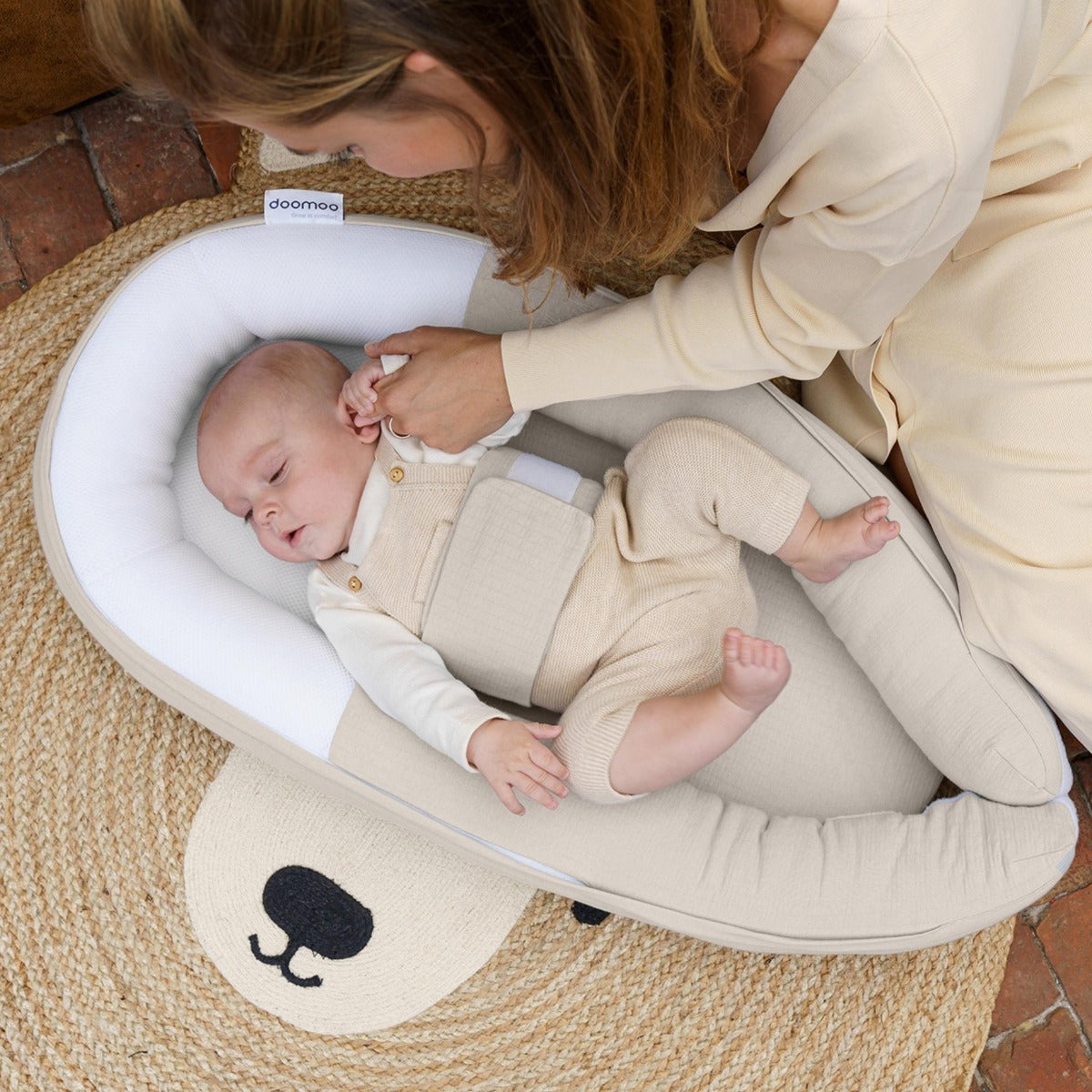 Baby holding hands with Mother in Doo Moo Cocoon nest in Tetra Jersey Sand