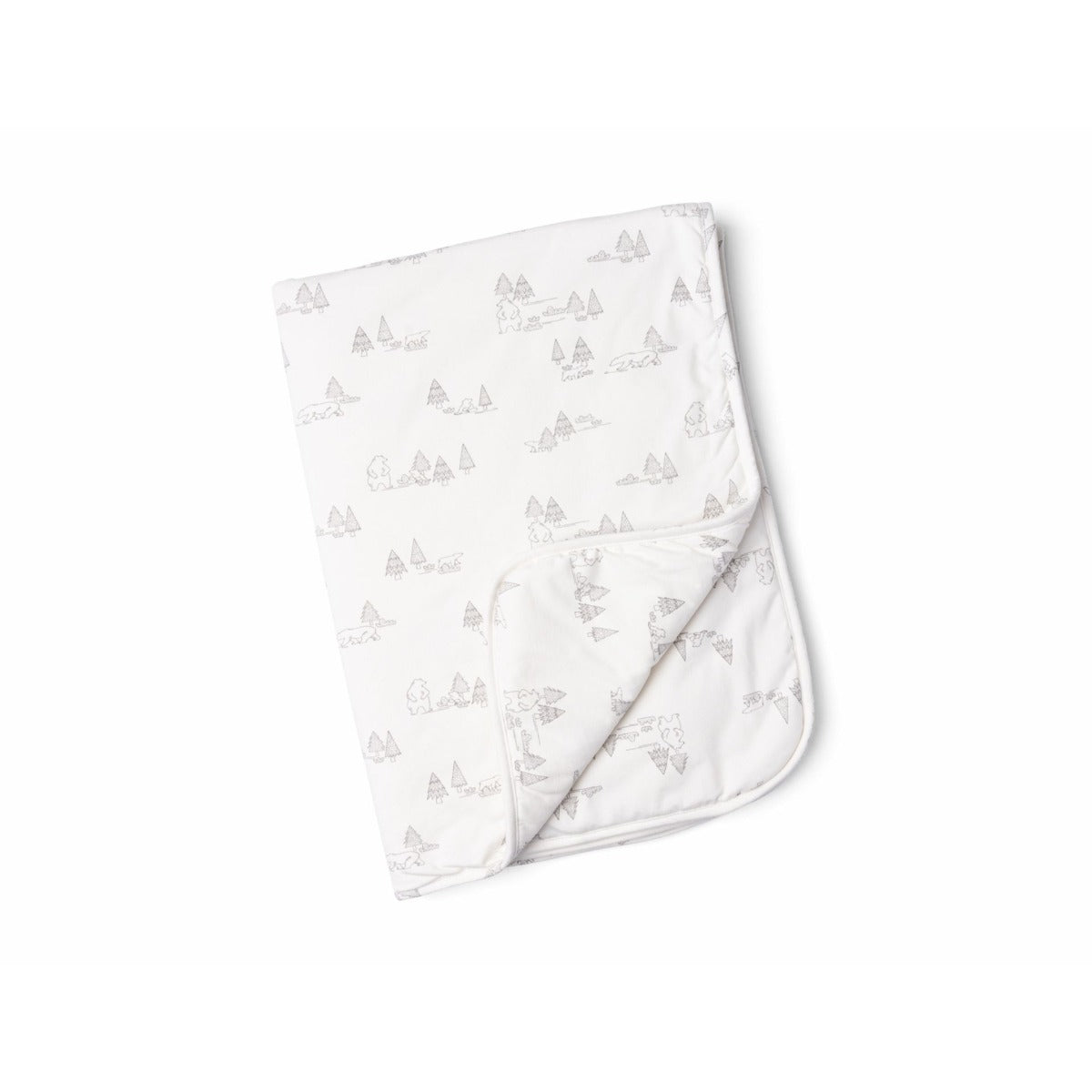 A folded white blanket with a subtle pattern of trees.