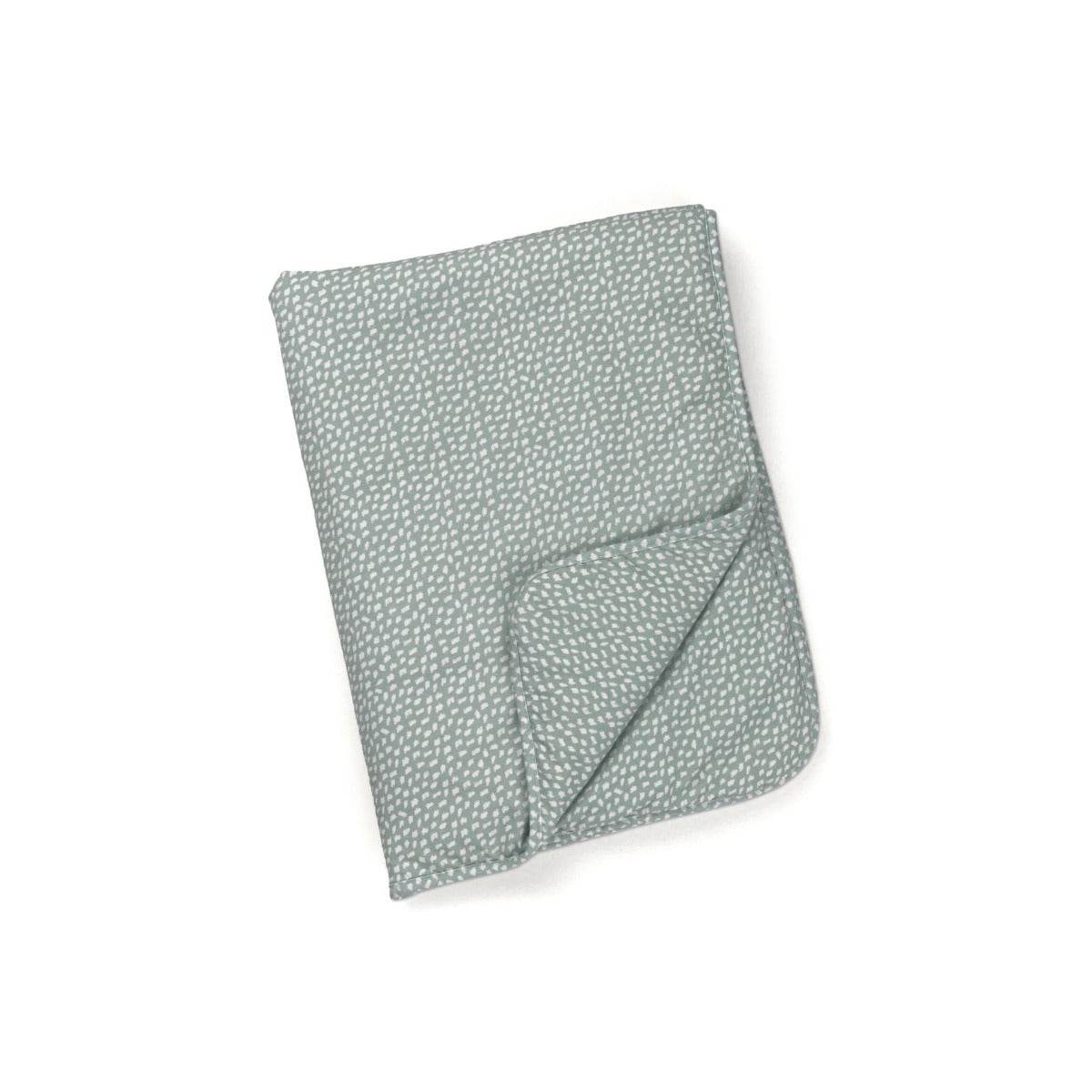 A folded green organic cotton blanket with a subtle star pattern.