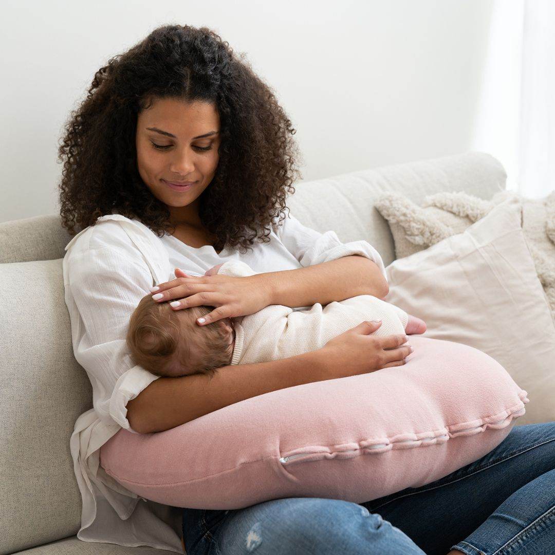 Mother breast feeding baby on Doo Moo Nursing Air Pregnancy Pillow Pink