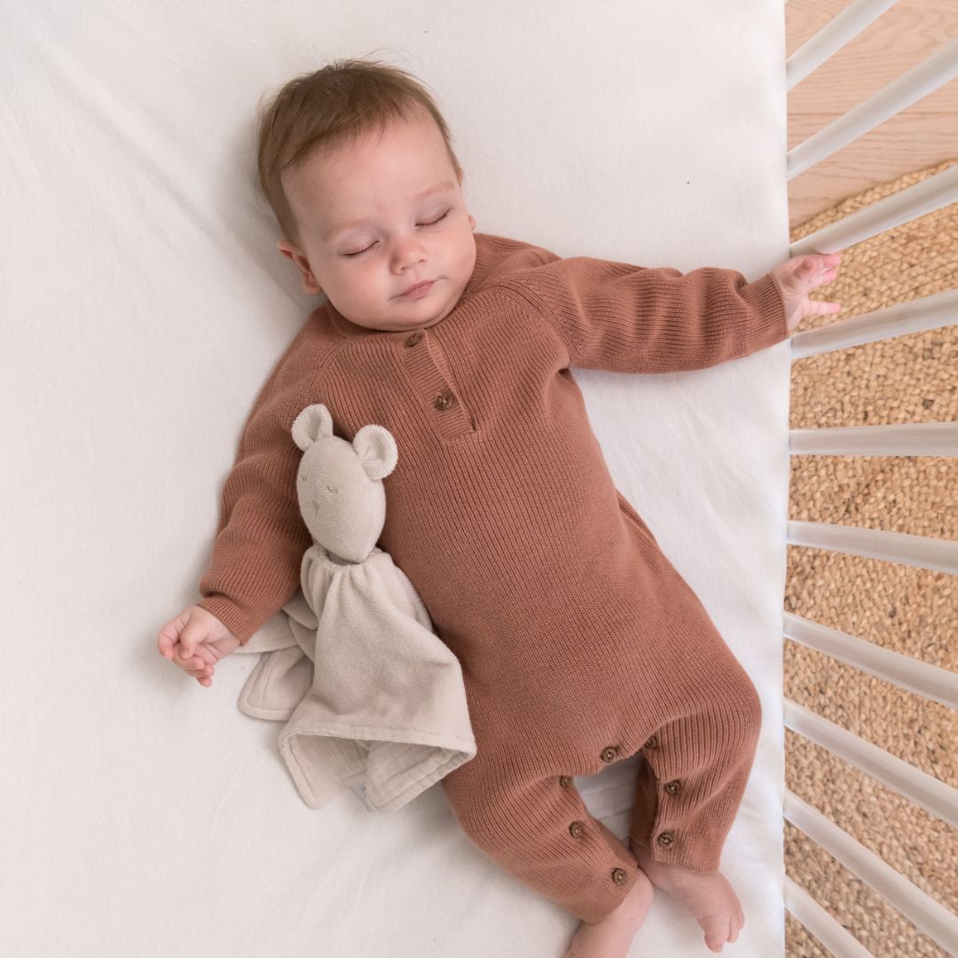 Baby sleeping in cot with doomoo bunny detachable baby soother in almond colour