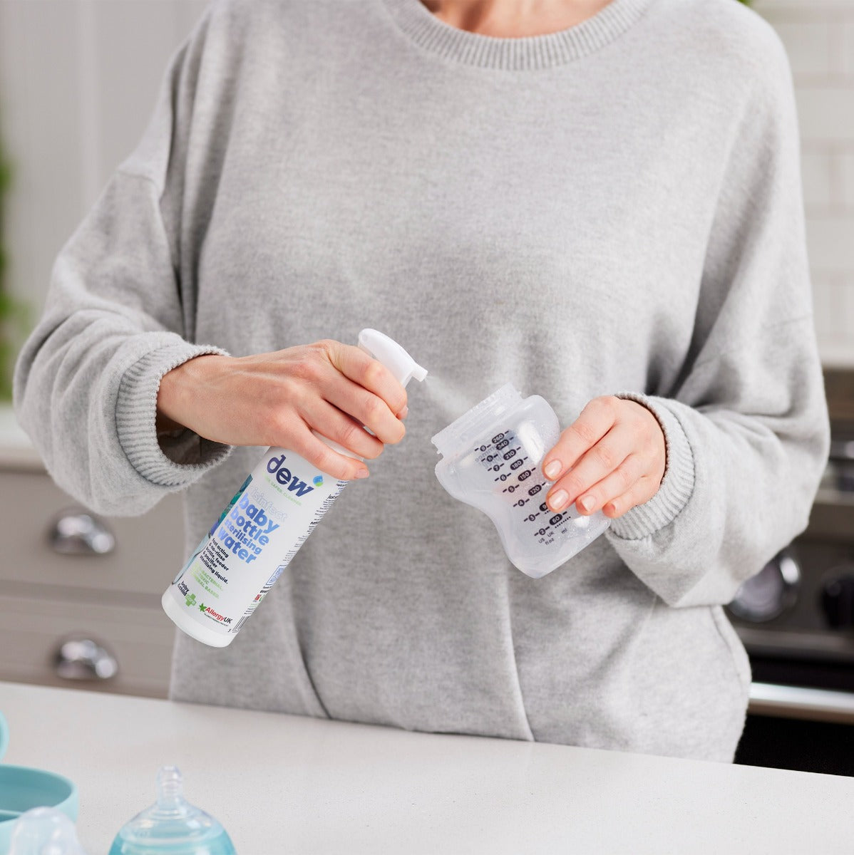 Mother using Dew Baby Bottle Sterilizing Water