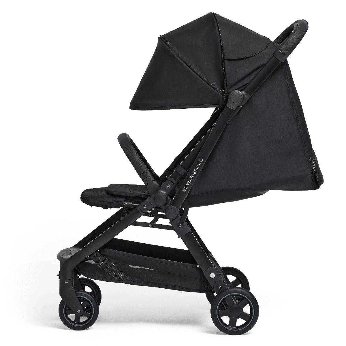 Edwards & co Lucci Stroller in black side view with hood down in laying position 