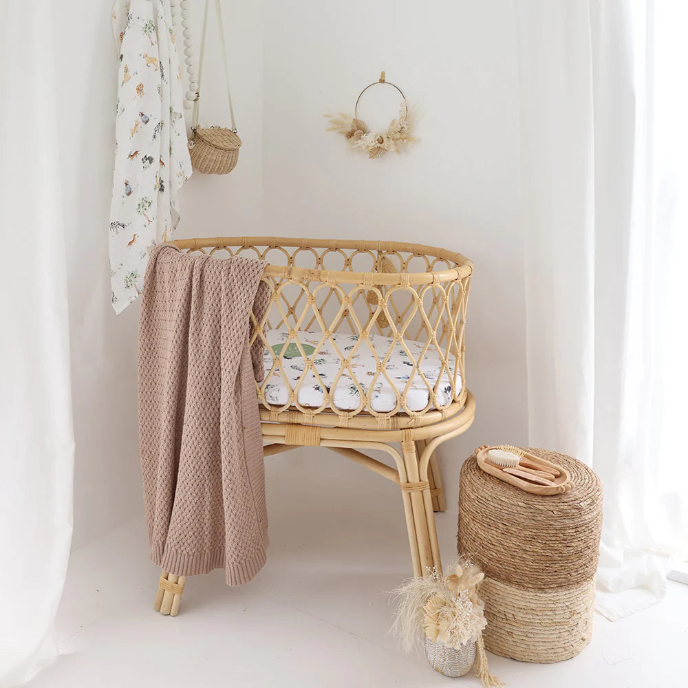 Organic cotton bassinet sheet over mattress in Moses basket