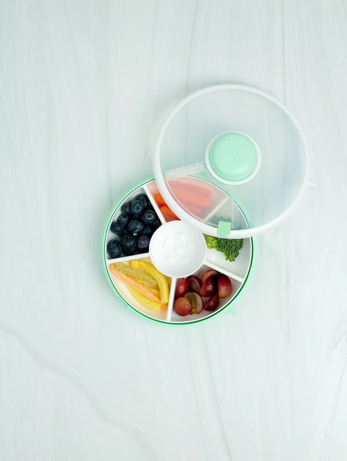 GoBee small snack spinner in teal and white filled with fruits and snacks and open top.