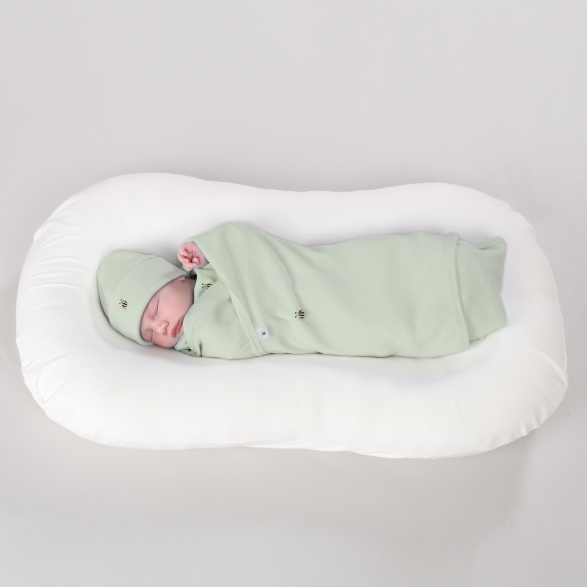 Dimples baby swaddles cotton snugglewrap in sage green on baby