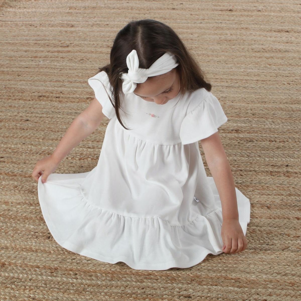 cotton tiered white dress with rose dimples lifestyle