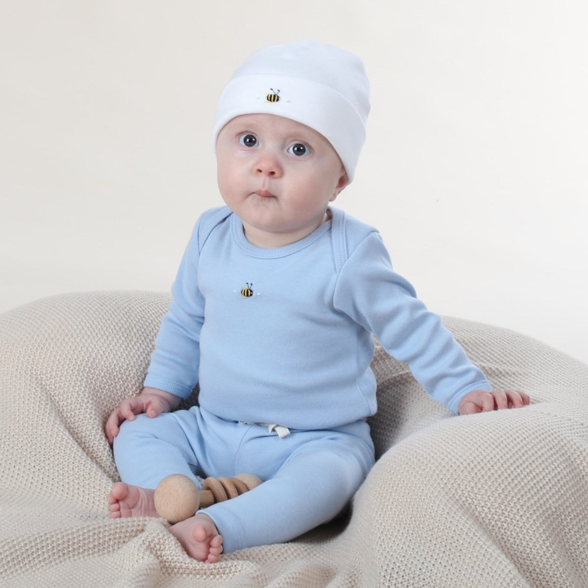 Dimples Baby clothing cotton beanie in White Bee on baby