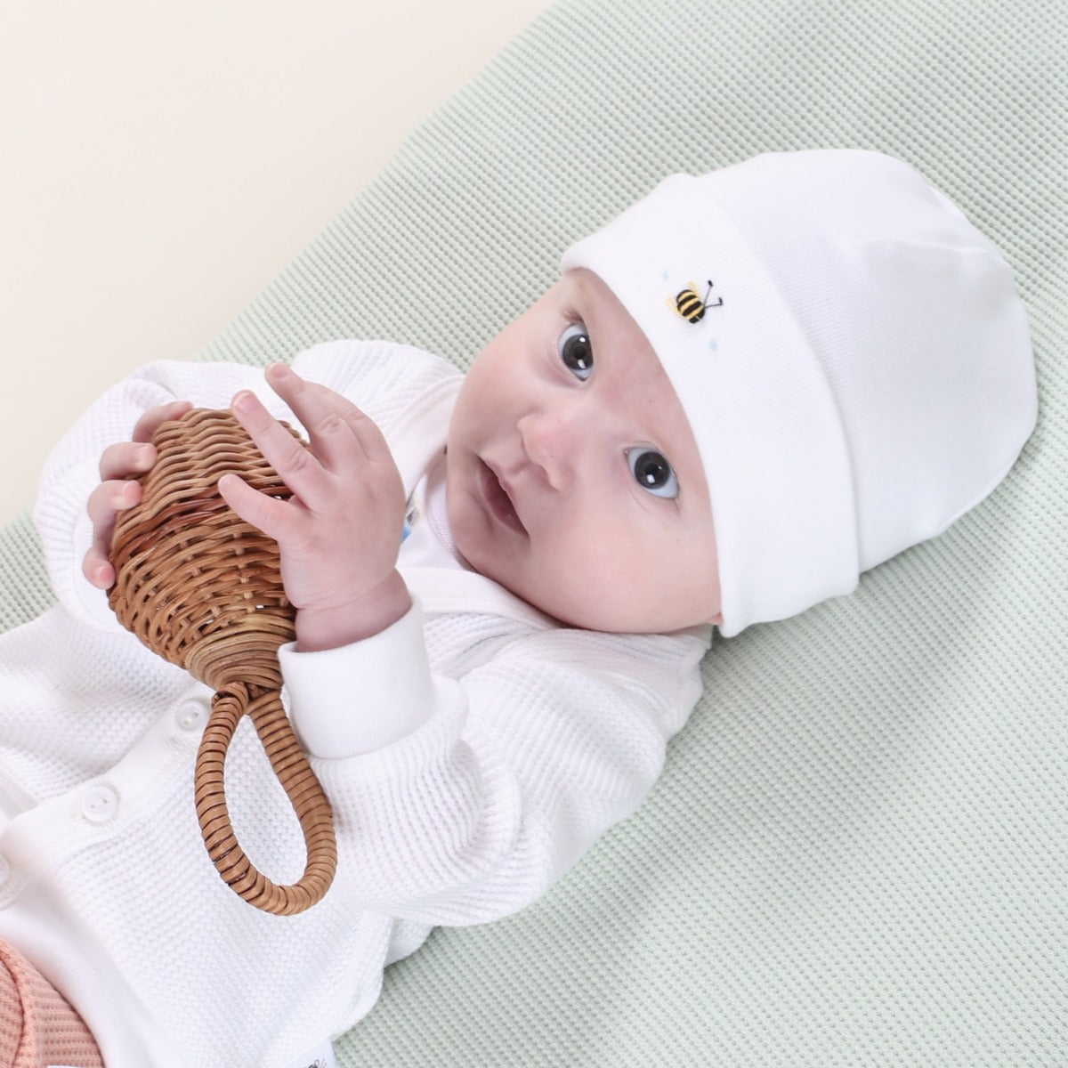 Dimples Baby clothing cotton beanie in White Bee on baby