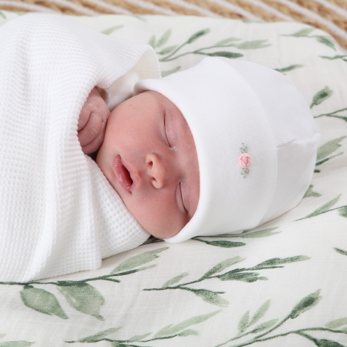 Cotton beanie white rose dimples close up