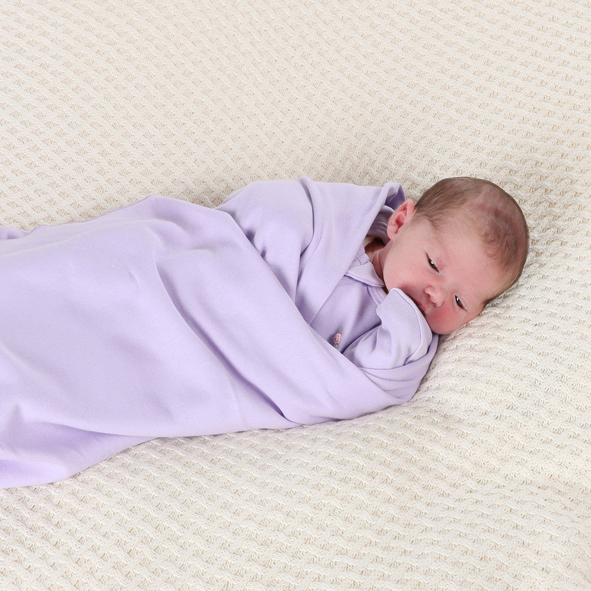 Baby sleeping wrapped in Lilac Cotton Baby Wrap wearing cotton sleep pod