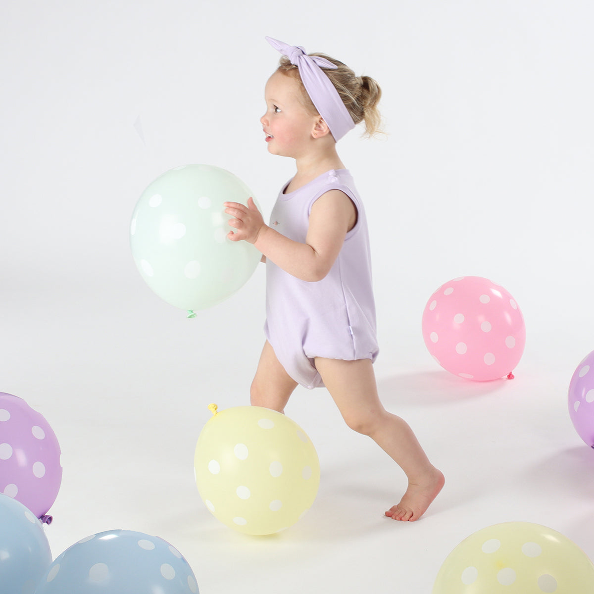 Baby girl playing wearing Cotton head band in lilac color
