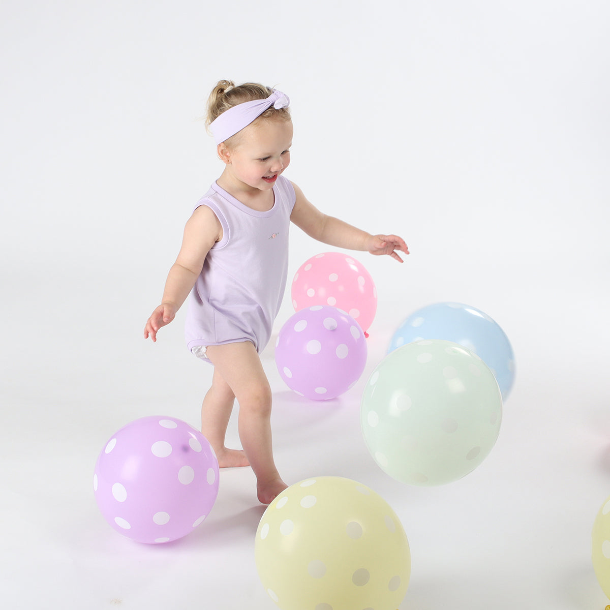 Baby girl playing, wearing Cotton head band in lilac color