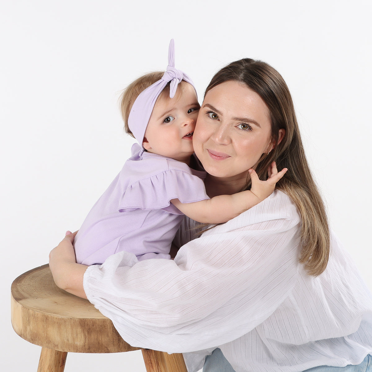Baby girl wearing Cotton head band in lilac color with her mother