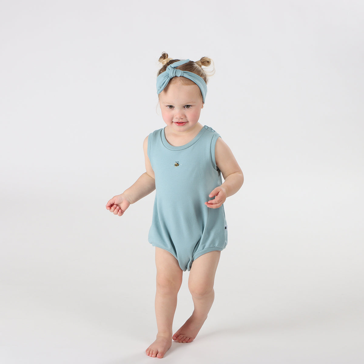 Baby girl playing wearing bodysuit Cotton Tie Headband in ocean