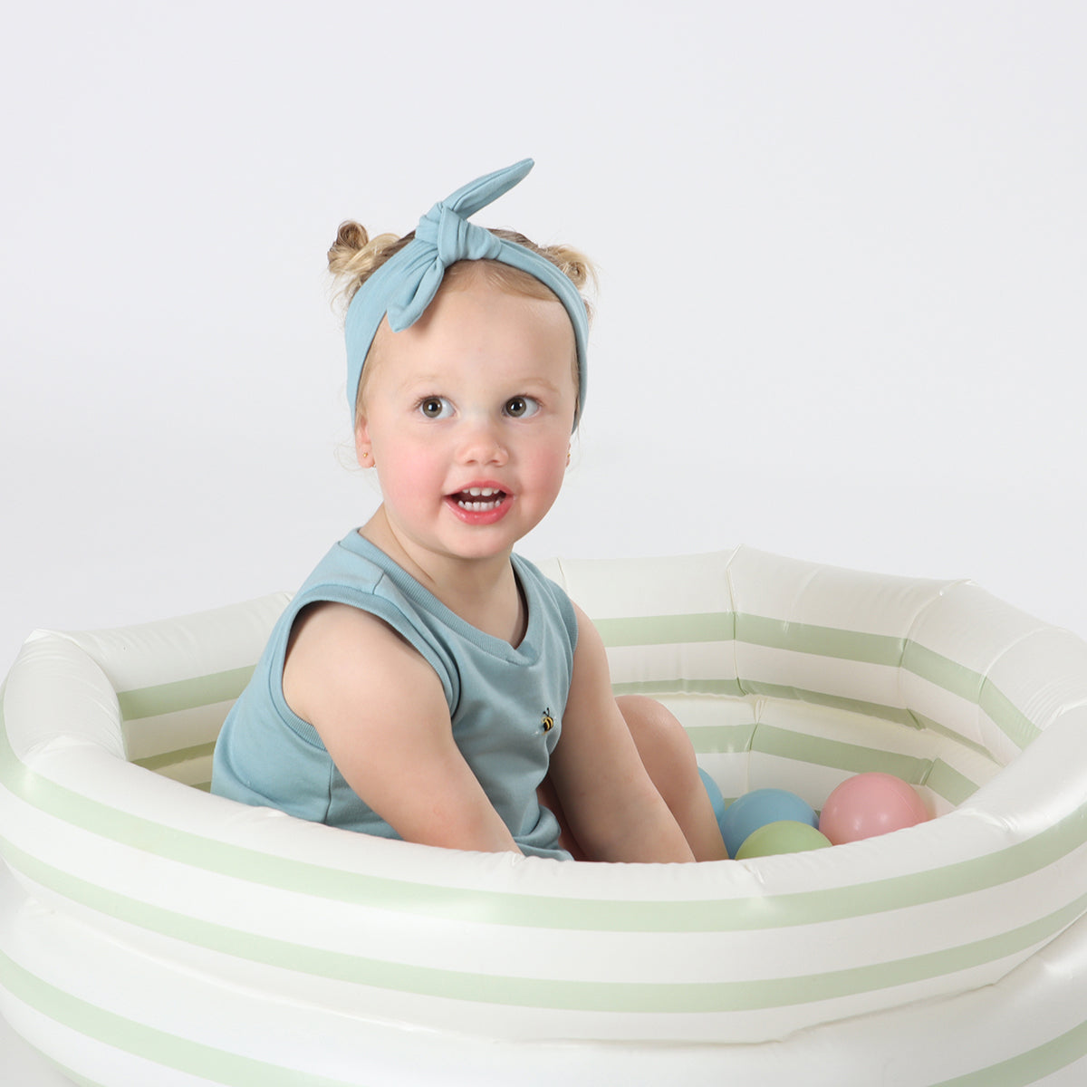 Baby girl playing wearing bodysuit Cotton Tie Headband in ocean