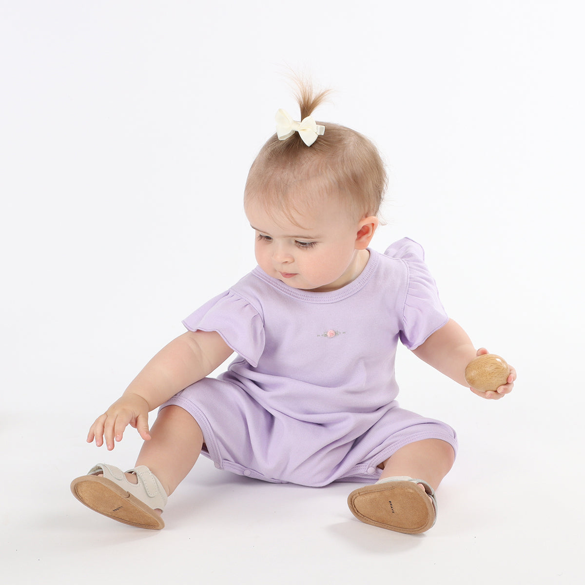 Baby girl playing freely by wearing Cotton Frill lilac romper with rose embroidery