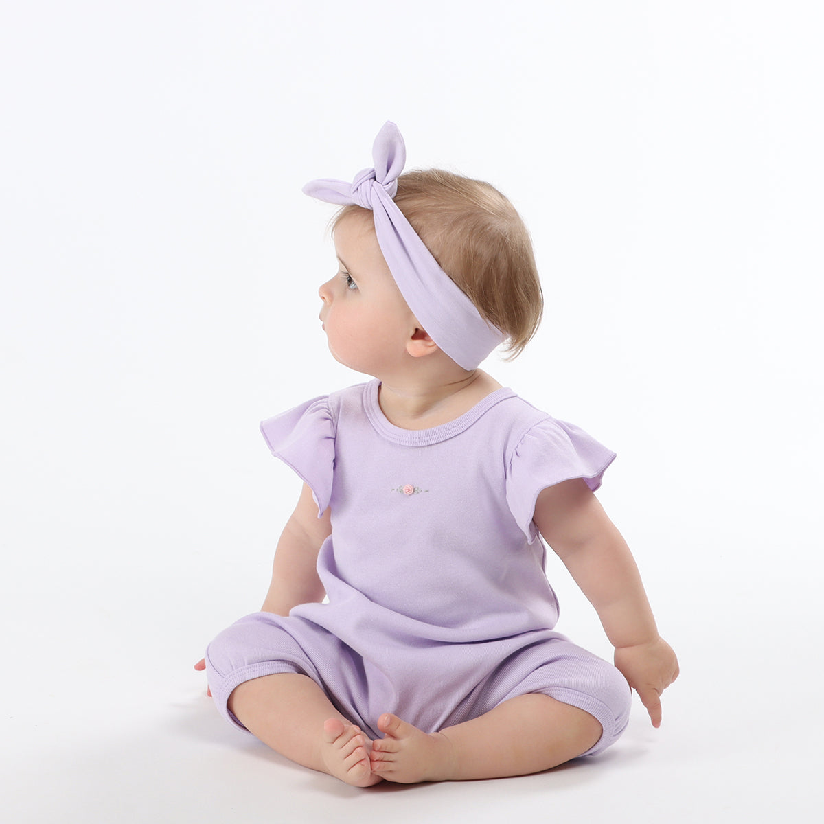 Baby girl wearing Cotton Frill lilac romper with rose embroidery with lilac cotton headband