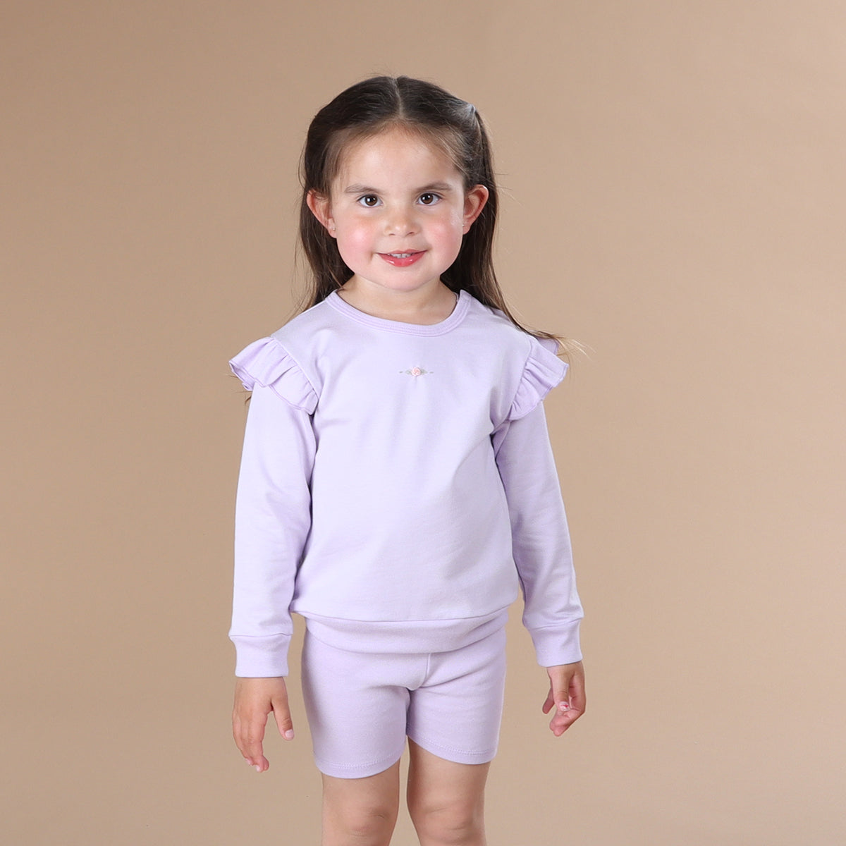 Little girl wearing Cotton Frill Jumper in lilac with rose embroidery
