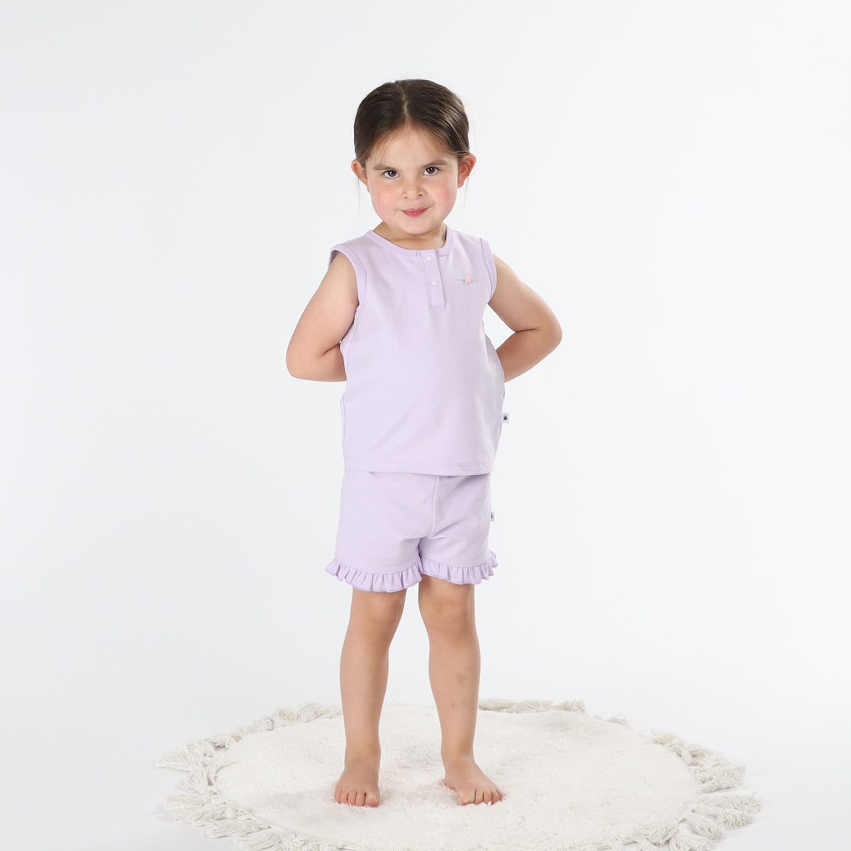 Baby girl wearing lilac frill shorts from Dimples front smiling face