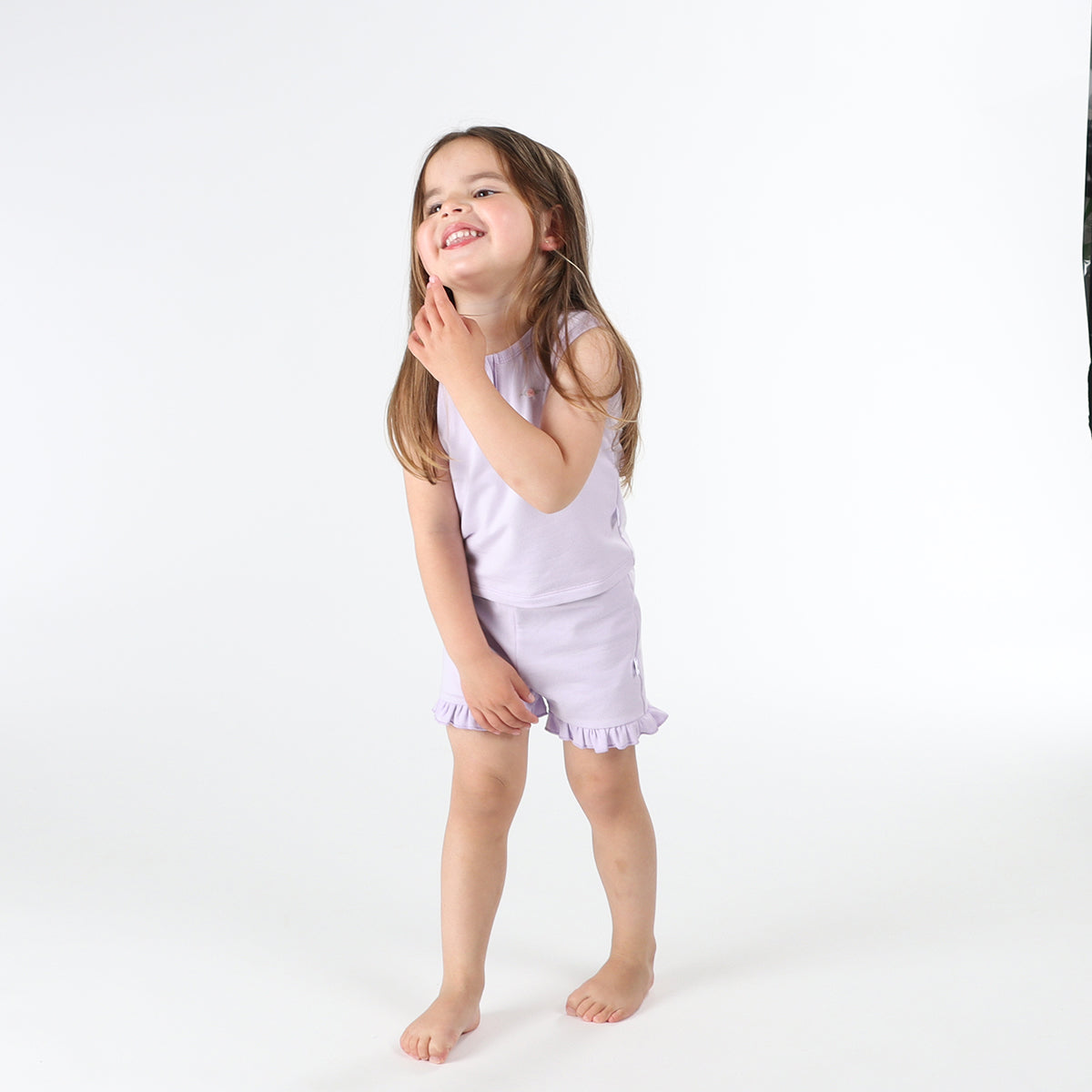 Baby girl wearing lilac frill shorts from Dimples front smiling face