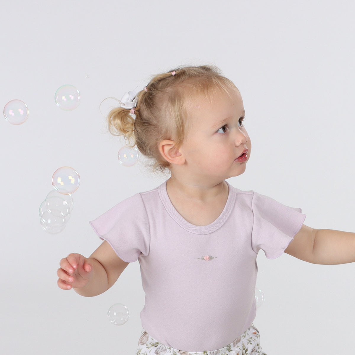 Baby girl wearing Cotton lilac Petal Bodysuit with rose embroidery