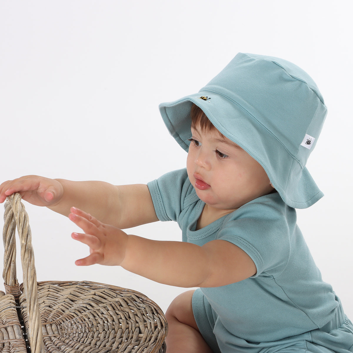 Cotton Bodysuit in Ocean bee pairing it with sunhat