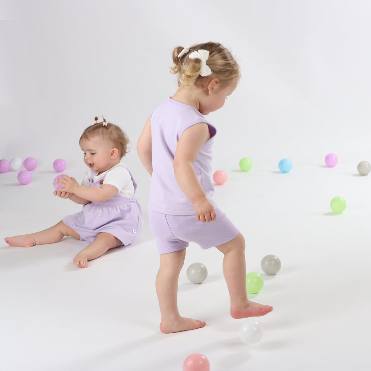 Baby girl wearing cotton lilac bike shorts and singlet from Dimples