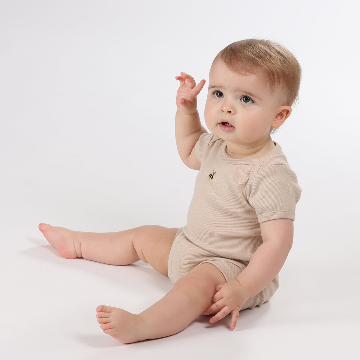 Baby wearing dimples biker shorts in sand bee colour from the summer 2024 hidden treasures collection