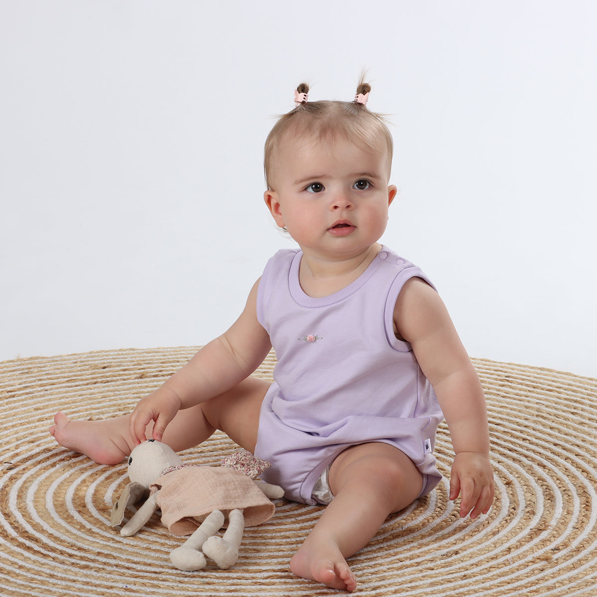 Baby sitting wearing Cotton Slouch Bodysuit in lilac with rose embroidery