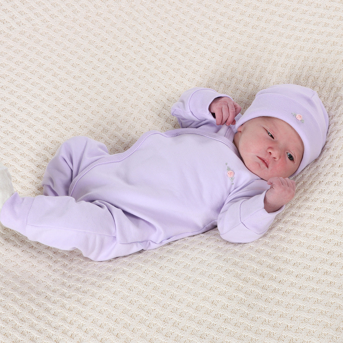 Baby sleeping wearing Cotton Beanie in lilac with rose embroidery